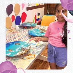 The pride in pointing out your own creation! This student is thrilled with the three beautiful resin art pieces made during our workshop.