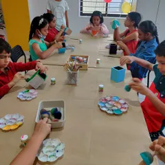 A fun birthday party where kids are painting and decorating their own pen stands and other cool projects.