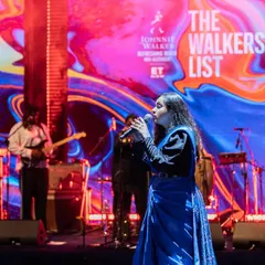 A vibrant moment on stage during 'The Walkers List' event. The colorful backdrop and stage lighting perfectly matched the high-energy fusion music we shared with the audience that evening.