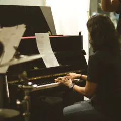 A musician lost in the moment, playing the piano during one of our electrifying Artist Sessions. We love hosting these events to showcase incredible talent and share live music with our community.
