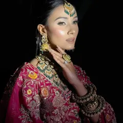 A stunning portrait from a creative shoot. The dramatic lighting highlights the model's sculpted features and the intense, glamorous makeup look.
