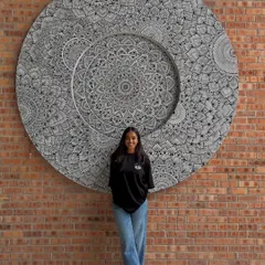 The final result. Standing proudly with the massive mandala mural I created and installed in Malaysia. This project proves that with faith in your work, anything is possible.