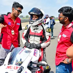 This is what our support looks like. Here, we're giving rider Meghana a pre-race briefing at her national debut in the INMRC. We provide full technical and motivational support to every rider, ensuring they are prepared and confident on the grid.
