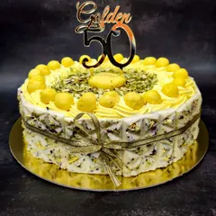 My Royal Rasmalai Cake is one of my bestsellers, perfect for celebrating major milestones like a 50th birthday. I infuse the light sponge with traditional rasmalai flavor and top it with actual rasmalai pieces, pistachios, and delicate gold leaf for a truly luxurious Indian fusion dessert.