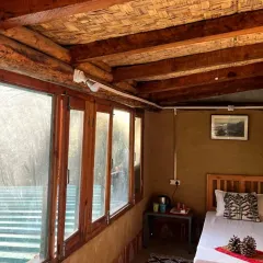 A look inside one of our rustic rooms at the Glamping Woods campsite in Mukteshwar. We've created a comfortable and natural space for you to rest and recharge after a day of adventure.
