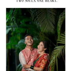 A joyful, candid shot of a couple sharing a laugh during their engagement photoshoot. They are dressed in vibrant traditional outfits, with the caption "Two souls, one heart" adding to the romance.