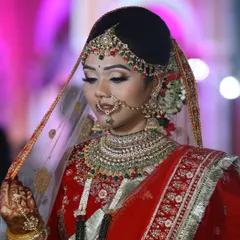 Our live bride looking radiant in her red attire. The makeup features a classic winged liner and bold lip, perfectly complementing the heavy jewelry and intricate outfit for her wedding day.