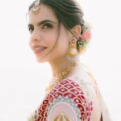 A beautiful close-up of the bride, Ashna. Her serene expression, combined with the delicate floral hair accessories and the soft Goan light, makes for a timeless and elegant bridal portrait.