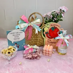 A sweet and thoughtful pamper hamper for a sister, featuring a cute tote bag, face masks, a bubble candle, shower gel, and a card that says "I couldn't have asked for a better sister than you!".