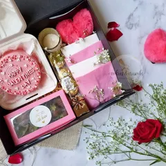 An inside look at the complete Valentine's Day hamper. It's a curated box of love, featuring a pink bento cake, a box of brownies, Ferrero Rochers, and other sweet surprises.