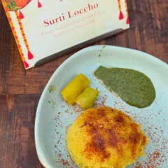 Surti Locho, a beloved savoury steamed snack from Gujarat, cooked in the traditional Khamni style. We take pride in perfecting regional delicacies to offer an authentic taste of home.