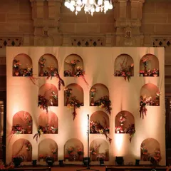 This center stage was designed as a wall of niches, each holding a unique floral arrangement, creating a stunning and artistic backdrop.