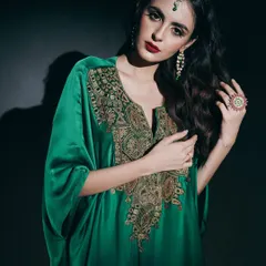 In this studio portrait, I used dramatic, low-key lighting to emphasize the luxurious feel of the emerald green kaftan. The focus is on the intricate gold embroidery and the model's commanding presence, creating a powerful image for a designer campaign.
