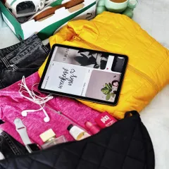A 'weekend vibes' flatlay showing what's in my bag: a colorful jacket, jeans, sneakers, an iPad, and beauty essentials. This is perfect for featuring multiple products in one shot.