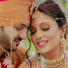 An intimate close-up of a Maharashtrian couple, their eyes closed in a moment of serene connection. The intricate details of the bride's mundavalya and nath tell a story of tradition and love.