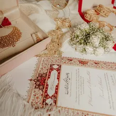 The elements of a promise. This flat-lay shot captures the beautiful details of a Nikah ceremony, from the marriage certificate to the bride's traditional jewelry.
