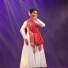 On stage, under the lights, I feel a divine connection. This photograph captures a moment of pure expression, where I am completely immersed in the rhythm and emotion of the performance.