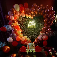 A closer look at the heart-shaped balloon decoration. The mix of metallic and pastel balloons against the shimmery backdrop creates a fantastic photo opportunity for the birthday person.