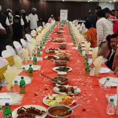 A view of our Dastarkhwan service in full swing. Our staff can be seen in the background ensuring every detail is perfect as guests enjoy the lavish spread at this wedding event.