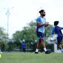 Coaching on the field is about clear communication and observation. Here, I am overseeing a drill, ensuring the athletes are executing the movements with the correct intent and technique to maximize the training effect.