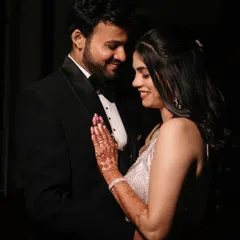 A tender moment between the couple, captured in a softly lit, romantic style that emphasizes their connection and elegant evening attire.