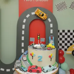 For a "Fast and Two Furious" second birthday, this cake features an edible racetrack and a collection of toy cars. It's a fun, interactive design that perfectly matches the high-energy theme of the party.