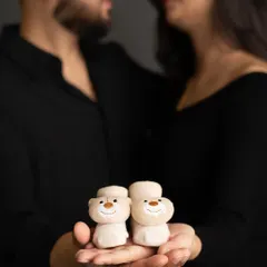 A creative close-up focusing on the tiny baby booties held by the parents-to-be. It’s a sweet and symbolic shot that represents the little life they are eagerly awaiting.