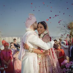 Pure joy. A candid moment of the groom embracing his bride after the ceremony, with guests celebrating in the background. These unscripted emotions are the best.