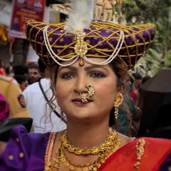 A portrait of a woman in full traditional attire, including a regal pheta. My close-up shots highlight the intricate jewelry and confident spirit of the participants.