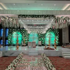 This is where fairytales come to life. I designed this ethereal mandap with a reflective glass aisle and a canopy of cascading white florals, creating a magical path for the couple to walk towards their forever.