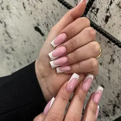 The quintessential classic French manicure on long, square-shaped extensions. This clean and timeless style is perfect for any occasion.