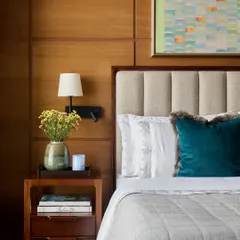 A bedroom should be a sanctuary. For the 'Pad by the Bay' project, we layered textures and warm materials like oak veneer and plush fabrics to create a serene retreat. The space is designed for rest, with curated art and soft lighting completing the calm atmosphere.