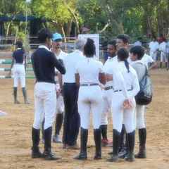 My team discussing strategy at the Auroville Horse Show. Success in this sport is a team effort, involving riders, coaches, and grooms working together.
