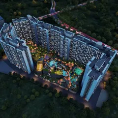 An aerial night view rendering of the Kohinoor Uptown township in Kalyan. This perspective shows how we integrate buildings with extensive landscaped areas, pools, and recreational zones to create a complete living environment.