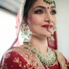 A stunning close-up of this Punjabi bride. The classic red lip, winged eyeliner, and the traditional nath create a timeless and beautiful look.
