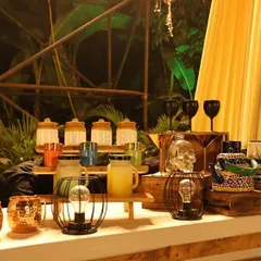 A quirky and eclectic bar setup perfect for a themed party. We used interesting props like a skull-shaped glass, a painted teapot, and unique lanterns to create a memorable and talk-worthy drink station.