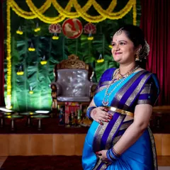 A candid moment of the expectant mother during her Seemantham ceremony. The traditional decor and her serene expression make for a timeless photograph.