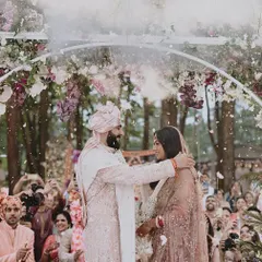 The magical Jaimala moment under a floral arch, with a shower of petals. This is a pinnacle moment of the ceremony, and we capture it with all its emotion and beauty.