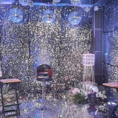 I can transform an entire space with floor-to-ceiling shimmer walls and hanging disco balls. This setup creates a glamorous, high-energy atmosphere perfect for milestone birthdays, sangeets, or New Year's Eve parties.