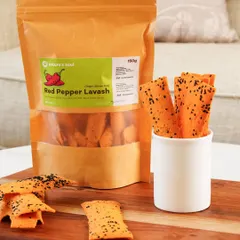 A shot of Red Pepper Lavash styled as a tasty snack. The product is shown both in its packaging and ready-to-eat in a crisp white cup, making it look appealing and convenient.