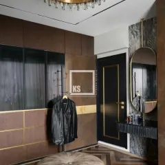 We created this moody and luxurious walk-in wardrobe using a combination of dark wood textures, ribbed glass, and brushed gold accents. The design includes a dedicated vanity area and smart storage, showing how we balance bold aesthetics with practical function.