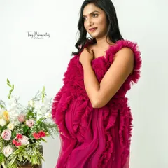 The vibrant magenta of this textured gown makes a bold and beautiful statement, celebrating the life and energy of motherhood.