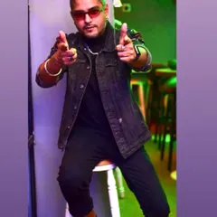 Locked, loaded, and ready to drop the madness. A confident pose in a denim jacket before a weekend of back-to-back gigs.