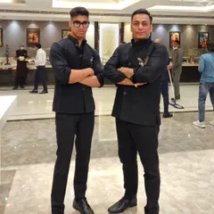 Like father, like son. Dressed in matching custom-tailored black Jodhpuri jackets, this is a moment of pride for our family and our craft.