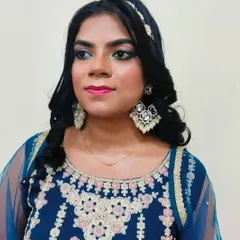 A simple and elegant engagement look created by a student. This style features soft smokey eyes, a bright pink lip, and gentle curls, perfect for pre-wedding functions.