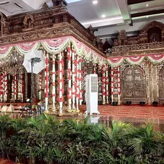 We can transform any convention hall with our grand, temple-style muhurtham stages, featuring intricate gold structures and traditional flower garlands.