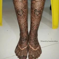 Another view of the detailed bridal leg henna, showcasing the floral and geometric elements.
