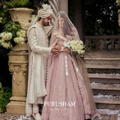 A quiet moment between a couple, where my design plays a supporting role. The groom's white sherwani, with its subtle all-over embroidery, is designed to harmonize perfectly with the bride's pastel lehenga, creating a picture of timeless elegance.