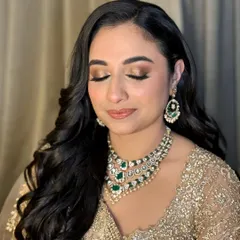 A close-up of Neha's reception makeup. The soft golden shimmer on her eyes catches the light beautifully, and her skin has a radiant, healthy glow that looks stunning.