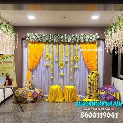This beautiful indoor Haldi setup features traditional marigold garlands, hanging floral elements, and a personalized welcome sign to greet your guests.